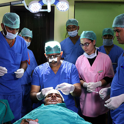 Dr Satya Saraswat with team during a hair transplant procedure